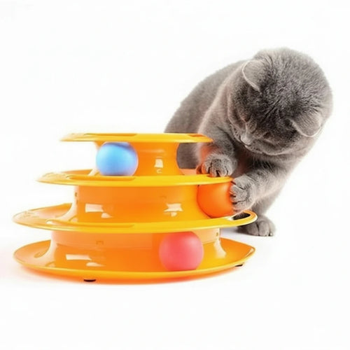Cat playing with a three-tiered orange cat toy with colorful balls on a white background